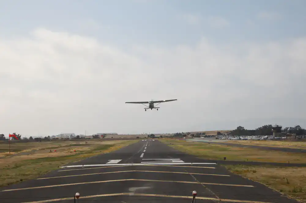 Small plane landing on dirt strip