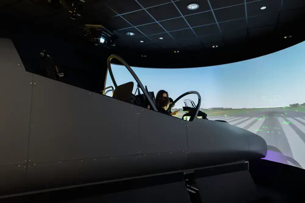 Simulator external view of an aircraft flaring perfectly over the runway threshold